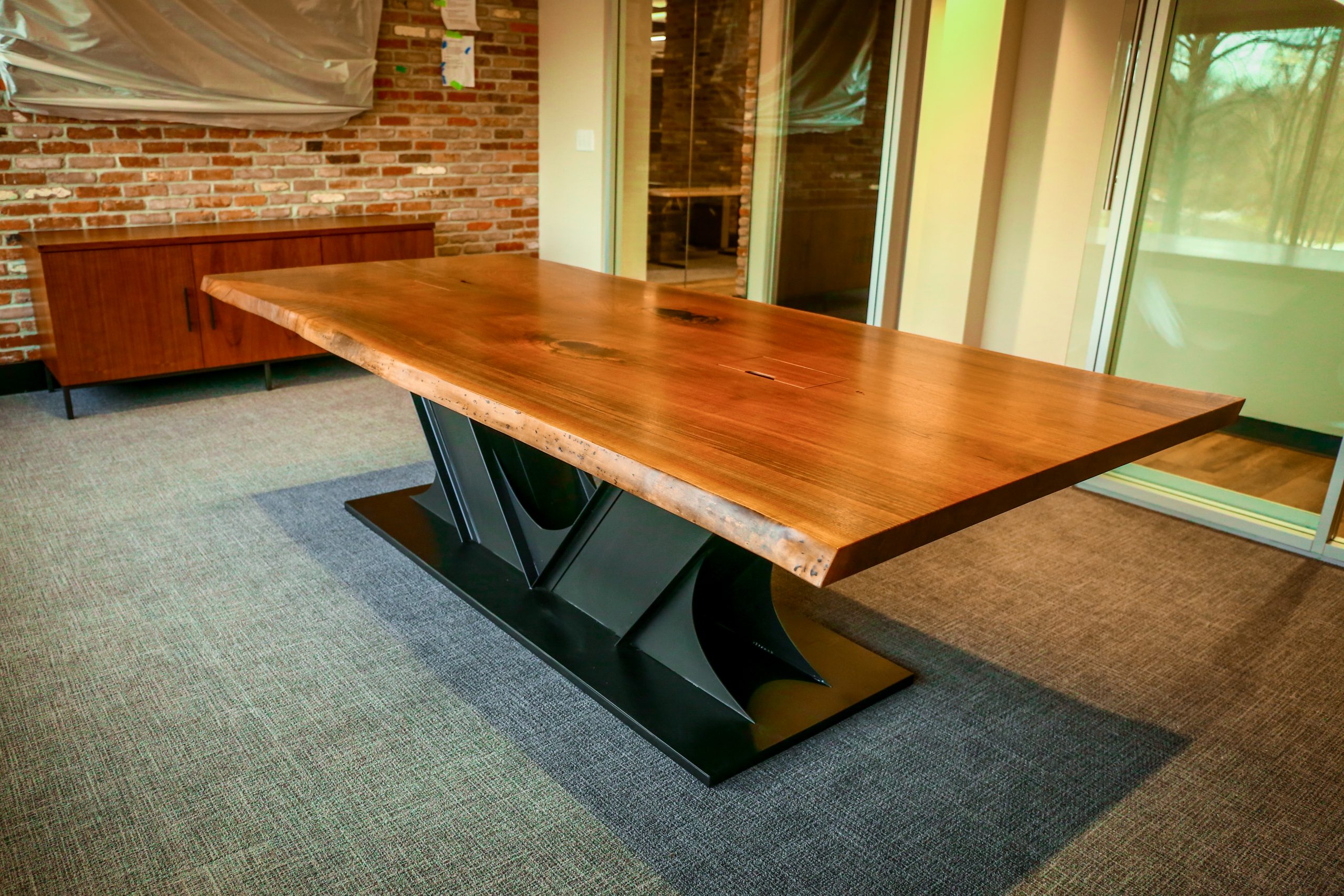 Custom industrial live edge conference table made with steel and ash, maple, red oak, white oak, or walnut wood.
